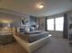 Comfortable main bedroom features neutral decor, bedside tables with lamps, and natural light at 197 Jetty Way, Davenport, FL 33897