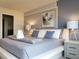 Stylish main bedroom suite features modern decor, bedside tables with lamps, and ample space at 197 Jetty Way, Davenport, FL 33897
