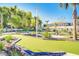 Well-manicured mini-golf course with palm trees, lighting, landscaping, and nearby buildings at 197 Jetty Way, Davenport, FL 33897