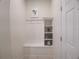 Mudroom with built-in bench, shelving, and coat hooks provides an organized entryway at 197 Jetty Way, Davenport, FL 33897