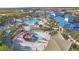 Resort-style pool with a splash park, seating areas, and lush landscaping for a luxurious outdoor experience at 197 Jetty Way, Davenport, FL 33897
