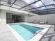 Beautiful screened-in pool area with comfortable lounge chairs, table and chairs, and inviting pool water at 197 Jetty Way, Davenport, FL 33897
