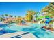 Lazy river pool with waterslide, palm trees, and bridge with lounge seating at 197 Jetty Way, Davenport, FL 33897