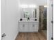 Spa bathroom boasts double vanity with stone countertops and tiled shower at 2065 East Pkwy, Deland, FL 32724