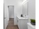 Bathroom includes undermount sink, wood floor, and large mirror at 2065 East Pkwy, Deland, FL 32724