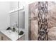 Modern bathroom featuring dual sinks, decorative tile accent wall, and a glass-enclosed shower at 2065 East Pkwy, Deland, FL 32724