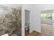 Bathroom featuring tiled shower, toilet, and entrance to an adjoining bedroom at 2065 East Pkwy, Deland, FL 32724
