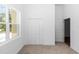 Bright bedroom with neutral carpet, closet and verdant view at 2065 East Pkwy, Deland, FL 32724