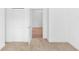 Bedroom featuring light carpet, closet, and an open doorway with beautiful wood flooring beyond at 2065 East Pkwy, Deland, FL 32724