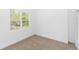 Well-lit bedroom with large window offering a view of the wooded outdoors and a closet nearby at 2065 East Pkwy, Deland, FL 32724