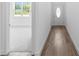 Bright entryway featuring wood-look flooring, a white door, and an open view into a carpeted room at 2065 East Pkwy, Deland, FL 32724