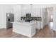 Modern kitchen features an island, stainless steel appliances and gorgeous wood flooring at 2065 East Pkwy, Deland, FL 32724