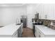 Bright kitchen boasts white cabinets, stainless steel appliances, backsplash, and a center island at 2065 East Pkwy, Deland, FL 32724