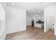 Bright, open living space with wood-look flooring, recessed lighting, and access to the kitchen and bathroom at 2065 East Pkwy, Deland, FL 32724