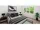 Stylishly furnished bedroom with a queen bed, modern art, and a window view offering ample natural light at 2065 East Pkwy, Deland, FL 32724