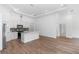 Spacious open-concept area connecting the modern kitchen to the living space with recessed lighting and wood floors at 2065 East Pkwy, Deland, FL 32724
