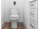 Close up of toilet showing stylish molding and wood floors at 2065 East Pkwy, Deland, FL 32724