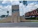 View of the Summit Village community sign with commercial buildings visible on a partly cloudy day at 207 Esplanade Way # 101, Casselberry, FL 32707