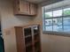 Bright hallway with built-in shelving, overhead cabinets, and a window offering ample natural light at 207 Esplanade Way # 101, Casselberry, FL 32707