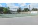 Outdoor tennis courts surrounded by a fence, providing residents recreational opportunities at 207 Esplanade Way # 101, Casselberry, FL 32707