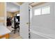 Bright bathroom showing a tiled bathtub and view into adjacent bedroom at 2288 Leland Ln, Casselberry, FL 32707