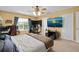 Large bedroom features carpeted floors, ceiling fan, natural light, and a large TV at 2288 Leland Ln, Casselberry, FL 32707