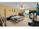 Bedroom with carpeted floors, yellow walls, ceiling fan, TV, and natural light from the window at 2288 Leland Ln, Casselberry, FL 32707