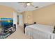 Bedroom with a ceiling fan, mounted TV, and neutral carpet at 2288 Leland Ln, Casselberry, FL 32707