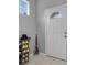 Welcoming entryway with tile flooring, shoe rack, and coat storage at 2288 Leland Ln, Casselberry, FL 32707