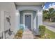 Inviting front entrance with covered porch and blue door at 2288 Leland Ln, Casselberry, FL 32707