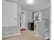 Hallway featuring carpeted floors, a closet, mini-fridge, shelving unit and access to bedrooms at 2288 Leland Ln, Casselberry, FL 32707