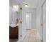 Hallway leading to powder room, featuring tile flooring at 2288 Leland Ln, Casselberry, FL 32707