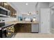This eat-in kitchen features stainless steel appliances and dark wood stained cabinets at 2288 Leland Ln, Casselberry, FL 32707
