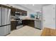 Cozy kitchen features stainless steel appliances, a tile floor, and wood-stained cabinets at 2288 Leland Ln, Casselberry, FL 32707