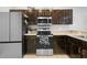 Charming kitchen features stainless steel appliances, dark-stained cabinets, and a tiled floor at 2288 Leland Ln, Casselberry, FL 32707
