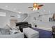 Open living area featuring tile floors, ceiling fan, neutral paint, and stairs to the second level at 2288 Leland Ln, Casselberry, FL 32707