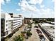 Aerial view of the community with buildings, parking, and landscaping under a partly cloudy blue sky at 2305 Edgewater Dr # 1604, Orlando, FL 32804