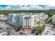 Wide angle aerial view of a modern condominium building with many windows, balconies, and green roof accents at 2305 Edgewater Dr # 1604, Orlando, FL 32804