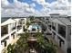 Stunning aerial view showcasing the community pool, lush landscaping, and architecture at 2305 Edgewater Dr # 1604, Orlando, FL 32804