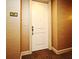 View of a condo's front door with the number 1604 and neutral colored walls and carpet in the hallway at 2305 Edgewater Dr # 1604, Orlando, FL 32804