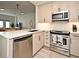 Modern kitchen featuring stainless steel appliances, a quartz countertop, and soft-close cabinetry at 2305 Edgewater Dr # 1604, Orlando, FL 32804