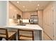 Bright kitchen features a white countertop, breakfast bar with chairs, stainless steel appliances, and white cabinets at 2305 Edgewater Dr # 1604, Orlando, FL 32804