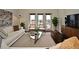 Bright living room featuring stylish decor, a comfortable sofa, and balcony access with natural light at 2305 Edgewater Dr # 1604, Orlando, FL 32804