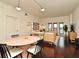 Bright living room featuring modern lighting, wood floors, a dining table, and access to a private balcony at 2305 Edgewater Dr # 1604, Orlando, FL 32804