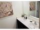 Elegant bathroom with double sinks, modern faucets, and decorative rose artwork at 239 Se 66Th Ct, Ocala, FL 34472