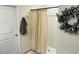 Clean bathroom featuring a shower with neutral-toned curtain, and a decorative wreath at 239 Se 66Th Ct, Ocala, FL 34472