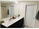 Bright bathroom with double sink vanity, white countertops, and a large mirror at 239 Se 66Th Ct, Ocala, FL 34472