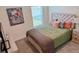 Comfortable bedroom featuring a full-sized bed and a window for natural light at 239 Se 66Th Ct, Ocala, FL 34472