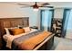 Inviting bedroom featuring a wooden bed frame, warm-toned bedding, and stylish decor at 239 Se 66Th Ct, Ocala, FL 34472