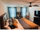 Inviting bedroom featuring a wooden bed frame, warm-toned bedding, and stylish decor at 239 Se 66Th Ct, Ocala, FL 34472